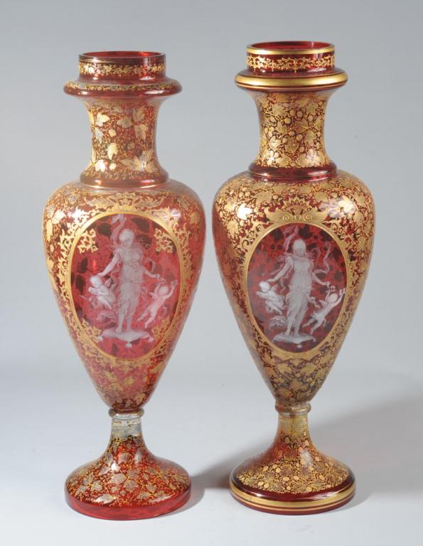 Pr. 19th C. Cameo Glass Urns: Near pair of large urns with extremely fine Thomas Webb & Sons type cameo scenes of goddesses in classical drapery with cherubs surrounded by lavish gilt fruiting vines on cranberry glass; one vase wi