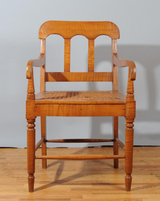 Southern Tiger Maple Arm Chair: Shaped crest rail above two straight, vertical splats, straight arms, and woven cane seat, supported by turned front legs and square rear legs, joined by turned box stretchers. Very good refinished co