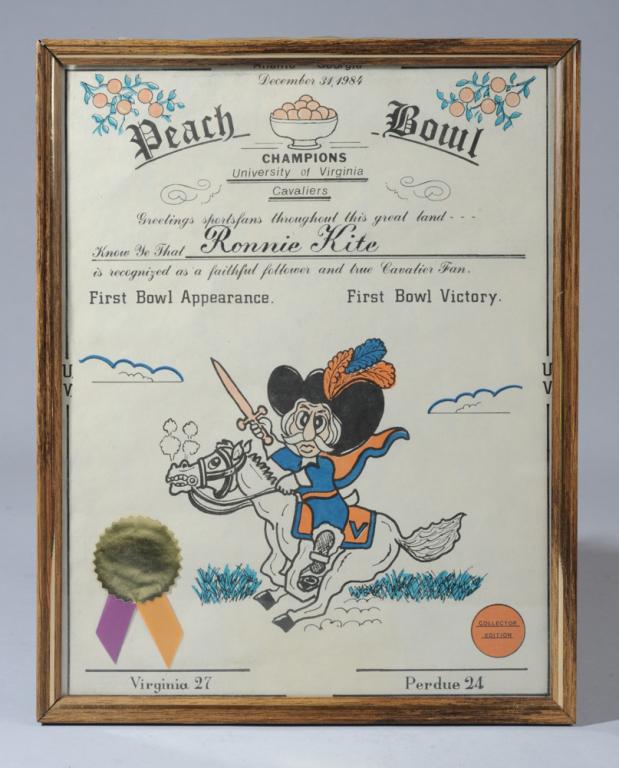 Ronnie Kite 1984 UVa Peach Bowl Certificate: 1984 University of Virginia Peach Bowl Champions fan certificate for Ronnie Kite, the late owner of Meadowbrook Hardware in Charlottesville. Framed (loosely).Approx. 14" x 11 1/4" frame.