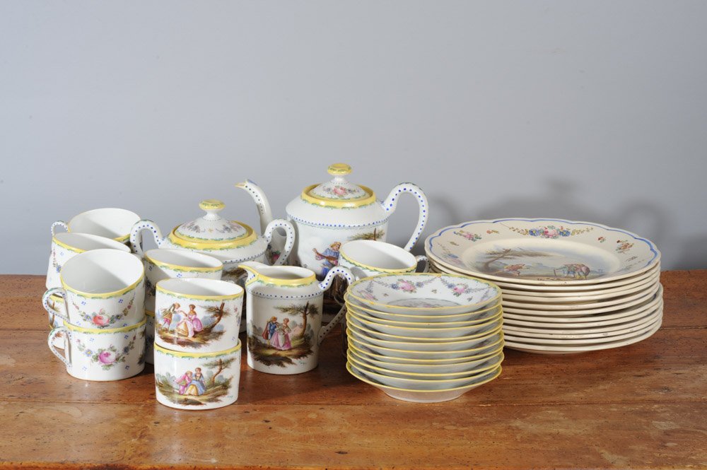 French Faience Porcelain Partial Service, 39 pcs: With floral decorations and rural scenes and courting couples, to include 12 cups, 12 saucers, 12 plates (dia: approx. 9 3/4"), Teapot, lidded sugar and creamer. All with green Lille France 1767 mark,