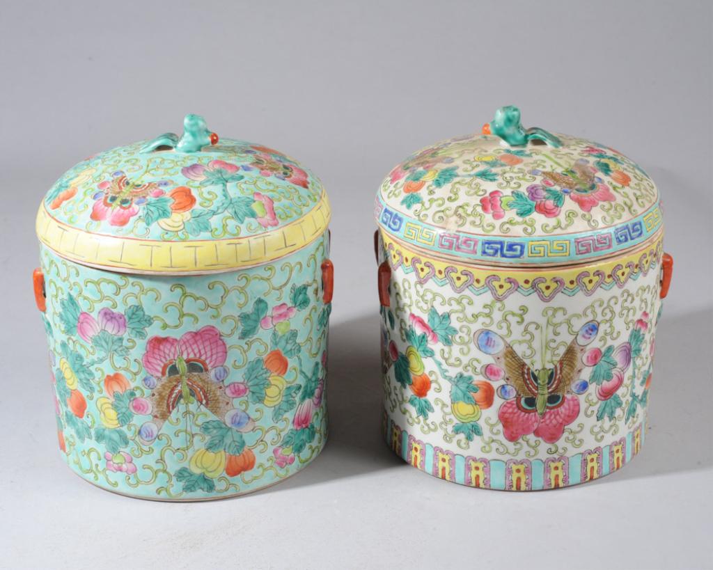 Two Chinese Famille Rose Canisters: One turquoise ground canister with colorful gourds, vines and butterflies in famille rose enamels. Four red lug handles. Foo dog finial. Tongxhi mark to base. Offered together with similar cannister w