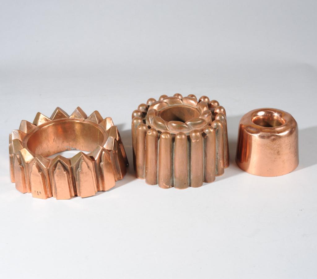 Three Antique Copper Food Molds, Jones Bros., etc.: Three antique copper jelly / food molds, including one marked for Jones Bros. Down St., one marked "N 23", and one marked "115".Tallest H: approx. 4".