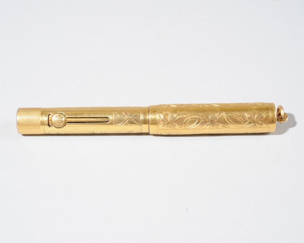 Waterman Ideal 0552 1/2 V Gold Plated Fountain Pen: Circa 1920s, with foliate decoration, lever filer, with damage to nib / in as-found condition.L: approx. 3 3/4".