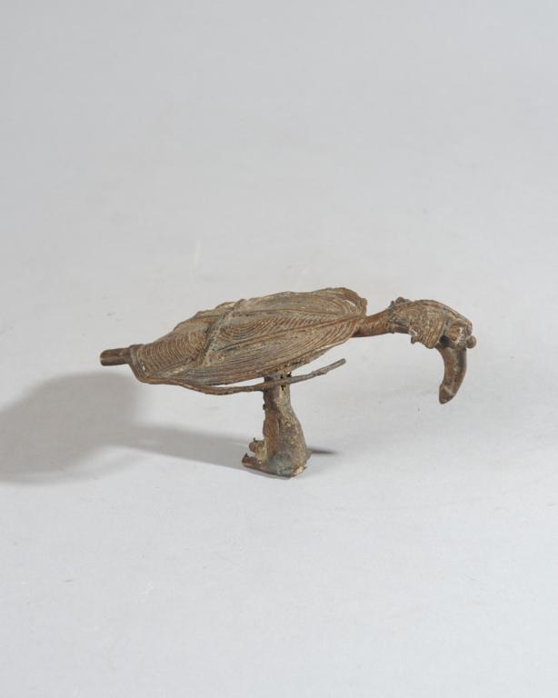 Old Lobi ? Bronze Hornbill Bird: Small cast bronze hornbill, its body abstracted to a disc, its expressive head, with characteristic cranial bump, long curved beak and round eye, appears wise and a little melancholy. Possibly Lobi. D