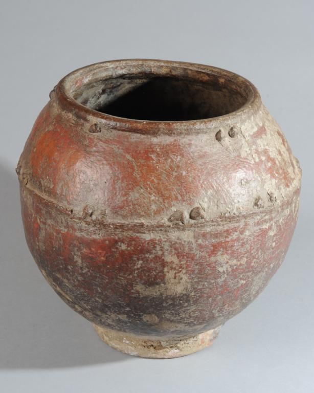 Bamana Storage Pot, Mali: Round terracotta pot with ridge and bosses at mouth and one third of the way down. Approx. 13" H., 14" D. Provenance: Estate of Thomas McNemar, (1931-2020.) McNemar lived and collected throughout Cent