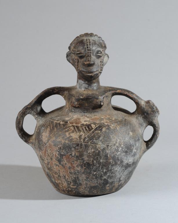 Songye Figural Ceramic Vessel: Blackened terracotta vessel in the form of a young woman, the head with plaited coiffure, half closed coffee bean eyes, gentle smile, relief keloid scars on cheeks and from hairline to tip of nose. Th