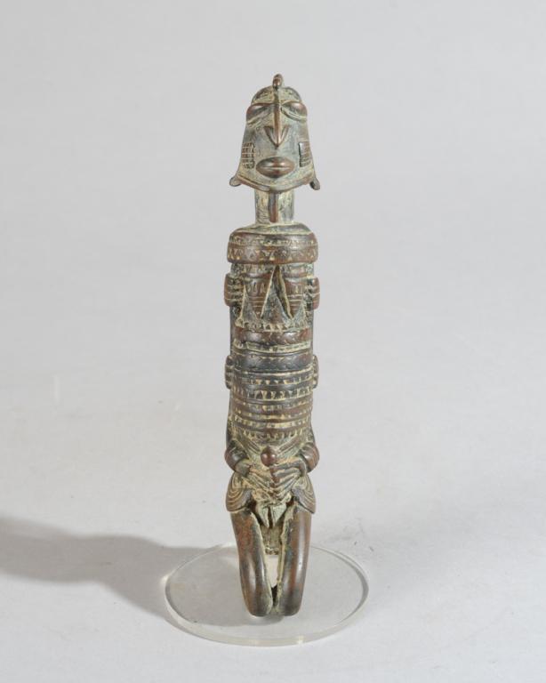Dogon Bronze Figure: Small but highly detailed Dogon bronze seated female figure, expressing great dignity in the uplifted head, her braceleted arms held close to her sides and her hands clasped below her protruding umbil