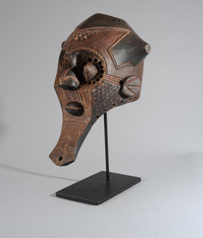 Kuba 'Bwoom Itok' Mask: Helmet mask as used in initiation and burial ceremonies, with characteristic cone shaped eyes surrounded by small holes and with a long spatulate chin or beard, the surface with incised, relief and pa