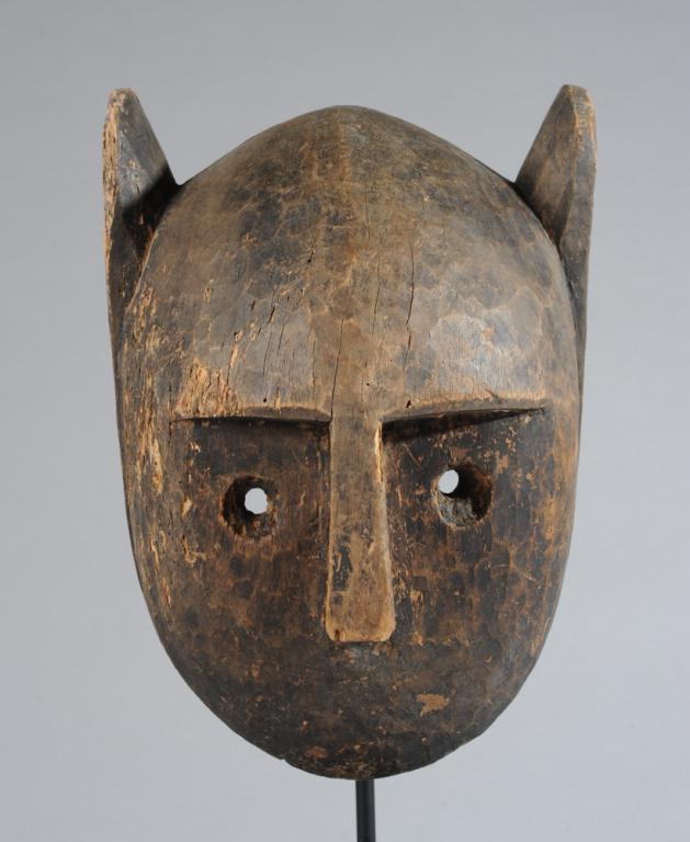 Bamana Animal Mask, Mali: Representing a lion, of simple form but with great presence; with short round ears and an open toothy mouth. Old insect damage. Includes custom gallery stand. Mask, approx. 13" H x 9" W x 7" D. Proven