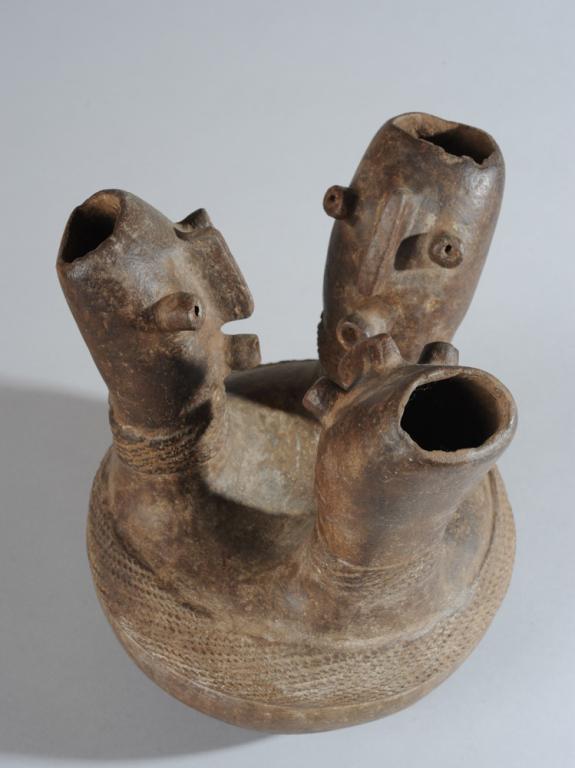 Congo Terracotta Figural Vessel: Round blackened terracotta pot with three elongated heads with abstract, almost robotic features, the eyes and mouths stalk-like, the nose a protruding bar. Openings at the top of the heads allow acce