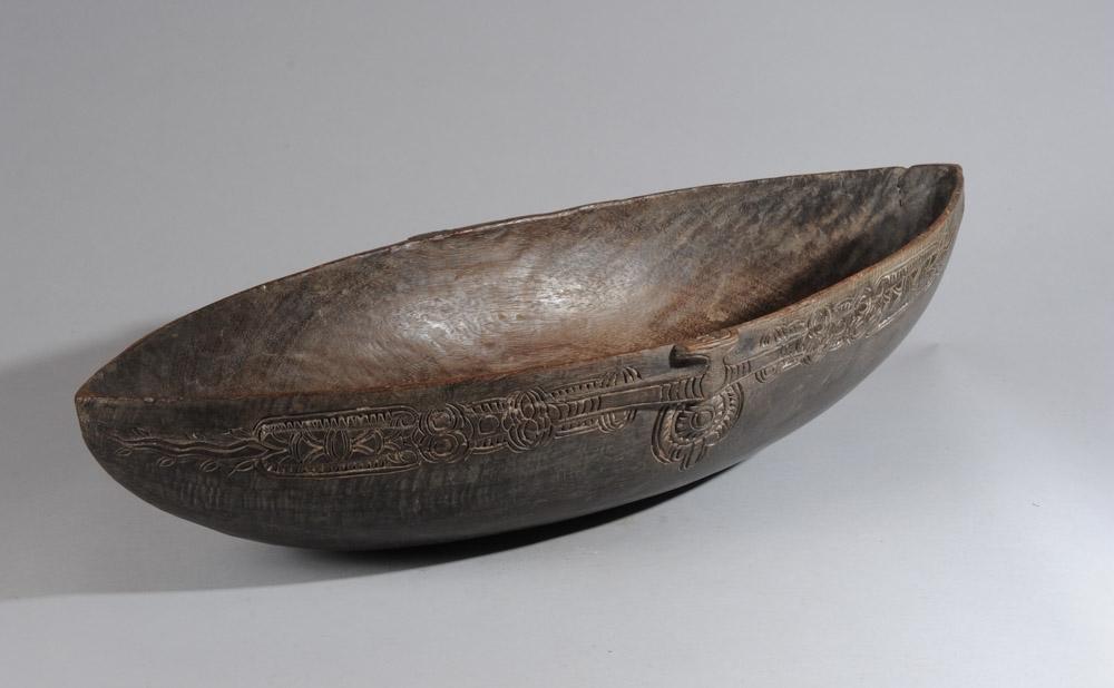 Carved Wood Bozo Trophy Boat, Mali: Beautifully carved wood small scale Bozo pirogue with incised decoration, excellent dark patina. Bozo people, Mali. Approx. 32 1/2" L x 15 1/2" W x 8" D.Provenance: Estate of Thomas McNemar, (1931-202