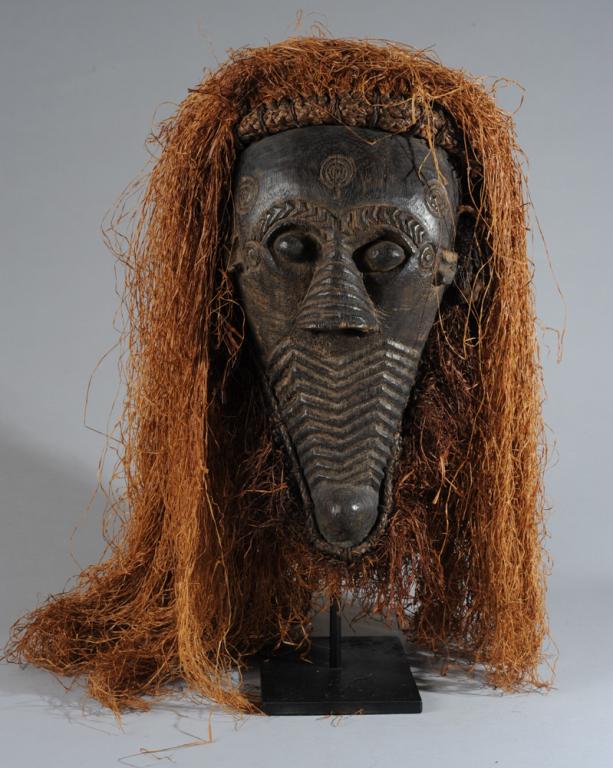 Lulua or Dengese Mask: An intimidating mask expressing vigor and power, the upper half a face with bulging but seemingly sightless eyes and large, ridged nose with enormous nostrils, the lower half of the face suggesting a 