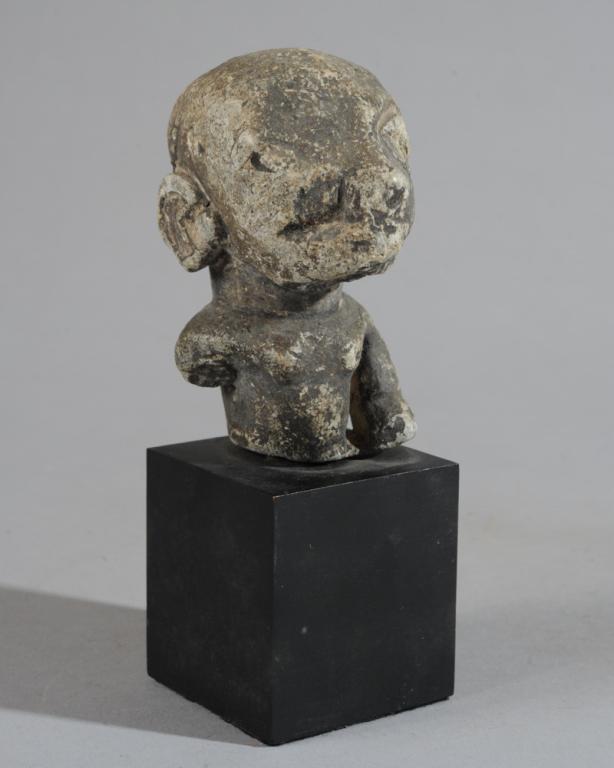 Kissi Nomoli Sherbro Stone Figure Sierra Leone: Carved stone bust with large, bulging eyes, ear plugs, relief cheek scarification and carefully rendered coiffure. A round cavity with raised rim at the top of the head suggests ritual use. Body is sh