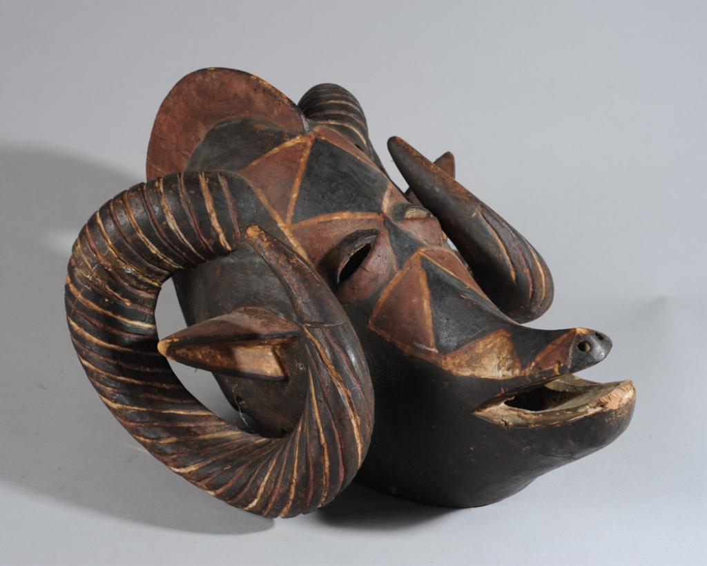 Bwa or Bobo Ram Mask, Burkina Faso: Ram mask with dramatically curving horns and swooping snout, with red black and white pigment. Bwa or Bobo (found with both designations in the collector's notes.) Approx. 22" L x 15" W x 13" D. Prove