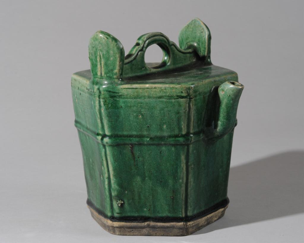 Chinese Qing Shiwan Glazed Water or Teapot: In the form of a Ming dynasty hexagonal water bucket, a green shiwan glazed spouted vessel, likely for tea or hot water. Unglazed base. No lid. Approx. 9" H. Collected in Asia in the 1960s-70s.