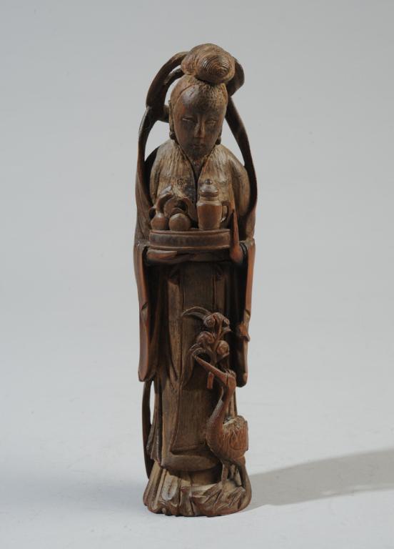 Carved Bamboo Figure of Xiwangmu or Guanyin: Finely carved Chinese figure, likely Xiwangmu, 'Queen of the West', carrying a tray of peaches and a pouring vessel, a water gourd strung on her back, and a crane at her feet holding sacred lingzhi fu
