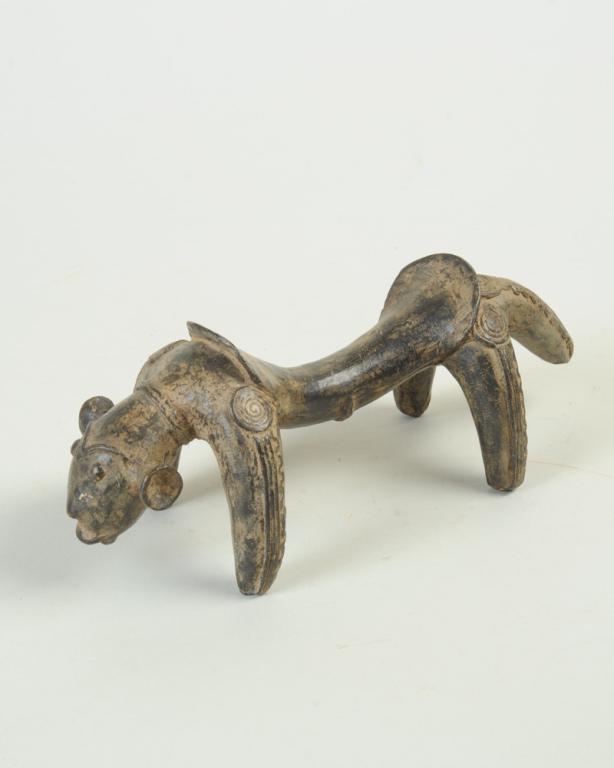 Bronze Zoomorphic Neck Rest: African headrest in the form of a four legged creature with conical ears and a human face. Possibly Chamba people. Approx. 9" L x 4" W x 4" H. Provenance: Estate of Thomas McNemar, (1931-2020.) McNema