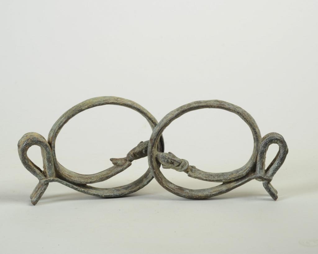 Dogon Bronze Couple Figures: Pare male and female bronze hoop figures, Mali. The female slightly larger, 7" H. Provenance: Estate of Thomas McNemar, (1931-2020.) McNemar lived and collected throughout Central and West Africa in t