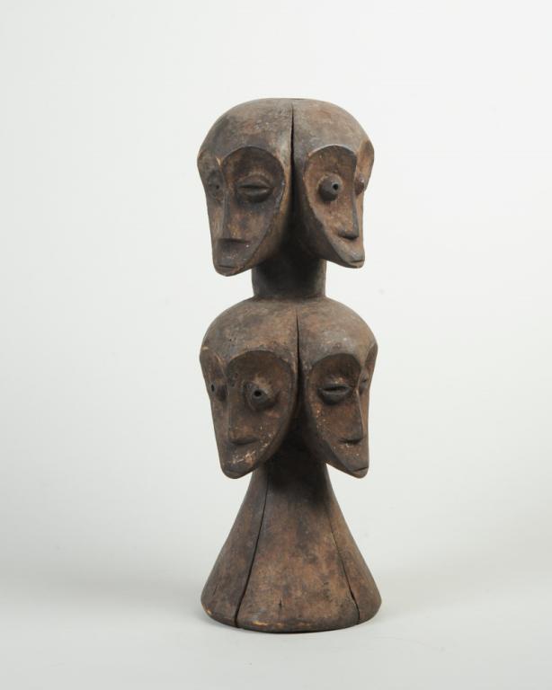 Lega Sakimatwematwe Figure: Bwami ritual object type sculpture with two tiers each with four opposing heads, identical except the eyes of every other face are wide open and staring, the remaining having half closed eyes. Approx.