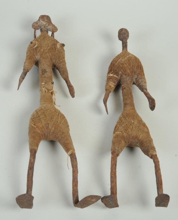 Pair Mumuye Iron Figures, Nigeria: Elongated iron male and female figures, their bodies wrapped with string. Possibly other material under the string in the heavily padded areas of the bodies. Female approx. 17 1/2" H., male figure app