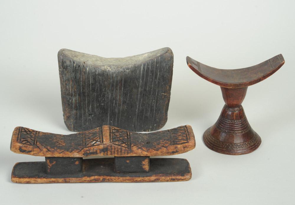 Three African Headrests: To include a Dogon double headrest from Mali, an Oromo headrest from Ethiopia with conical base and narrow neck below crescent shaped neck support, and a flat-sided Sidamo headrest, also from Ethiopia