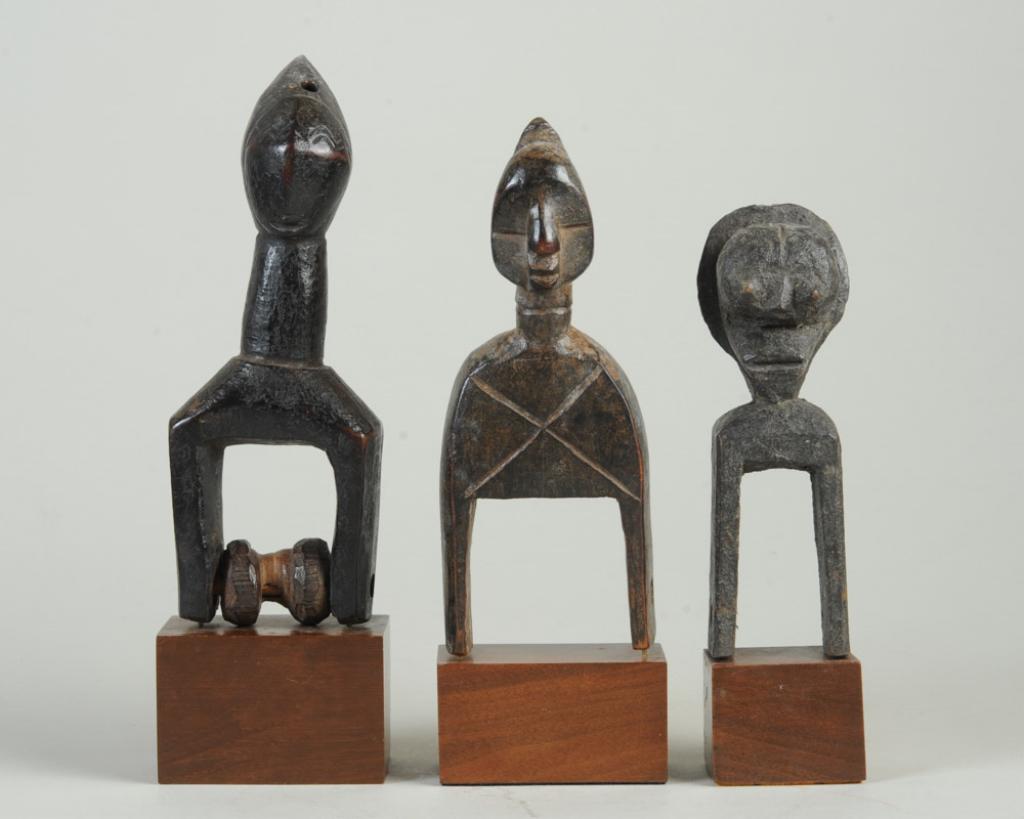 Three African Heddle Pulleys: With anthropomorphic finials. All on custom gallery bases. Largest pulley, approx. 7 5/8" H. Provenance: Estate of Thomas McNemar, (1931-2020.) McNemar lived and collected throughout Central and West