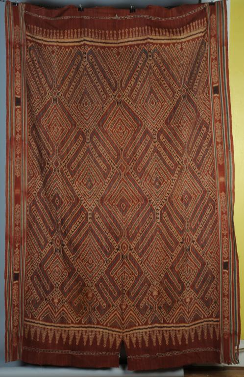 Toroja Ikat Shroud or Wall Handing Textile: Vintage or antique ikat shroud, also used as wall hangings to demark space for ceremonial events. Bold red, black and blue geometric designs in hand spun cotton. Celebes Island (Sulawesi) Indonesia. A