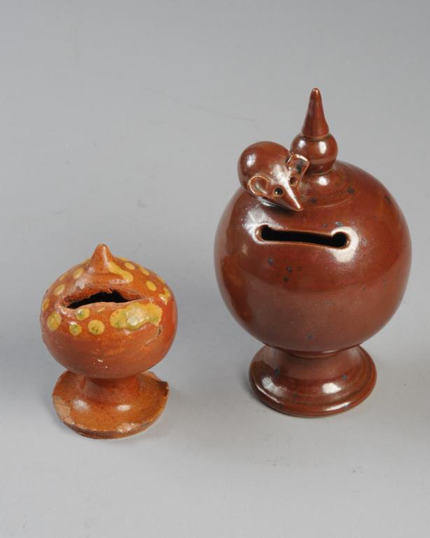 Redware and Brownware Footed Banks: Smaller redware bank with yellow accents, chips to base, brownware bank with applied mouse.Tallest H: approx. 6 1/2".