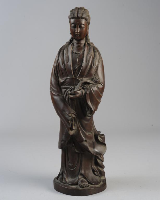 Chinese or Japanese Carved Wood Guanyin: Standing figure of Guanyin / Kwan-Yin or other deity, with downcast eyes, long unbound hair, wearing a necklace, flowing robes, and holding a ruyi sceptre in one hand. Age cracks, Approx. 16 1/2" H. P