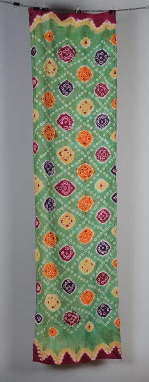 Vintage or Antique Indonesian Tie Dyed Textile: 'Pelangi' shoulder cloth with purple, orange, yellow and magenta on a grass-green ground. Approx. 78" x 21". Acquired in the 1970s-1980 by the original owner, a collector who purchased many of his ant