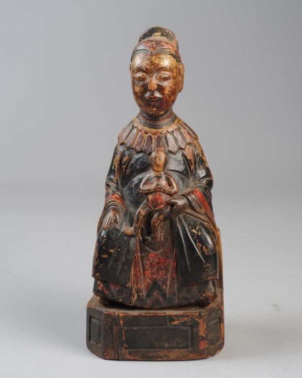 Chinese Carved Wood Mother & Child: Carved wood with traces of polychrome. Seated mother in cloud collar and robes holds smiling infant in her lap. Approx. 11 3/4" H. Provenance: Estate of Cayce Odom of Charlottesville, VA.