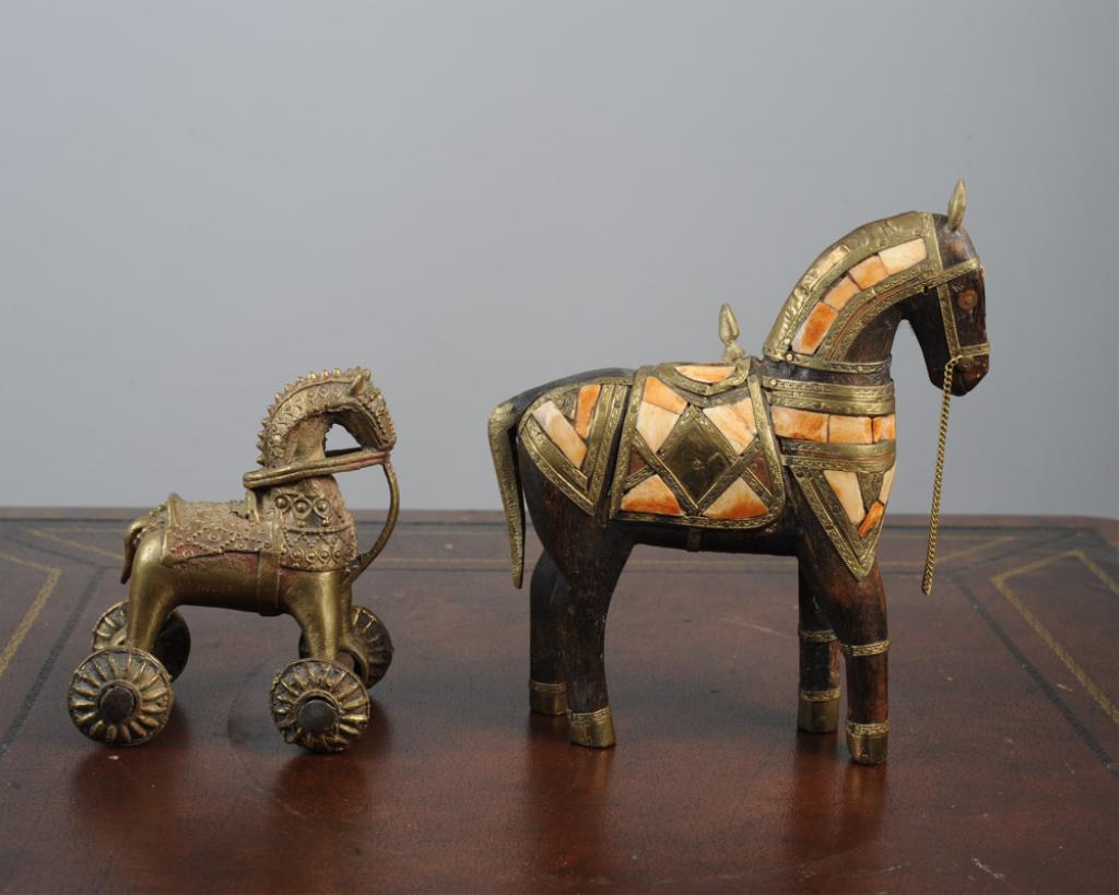 Two Figures of Horses, India: A Rajasthani Marwari bone and brass inlaid wooden horse, offered together with a Hindu temple tooy wheeled brass horse. The Marwari horse approx. 8" H.