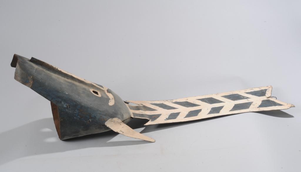 Metal Mask, Mali?: Large zoomorphic mask made of formed and painted sheet / scrap metal, possibly a Dogon or Bamana animal mask, Mali. Approx. 37" L, 13" W. Provenance: Estate of Thomas McNemar, (1931-2020.) McNemar liv