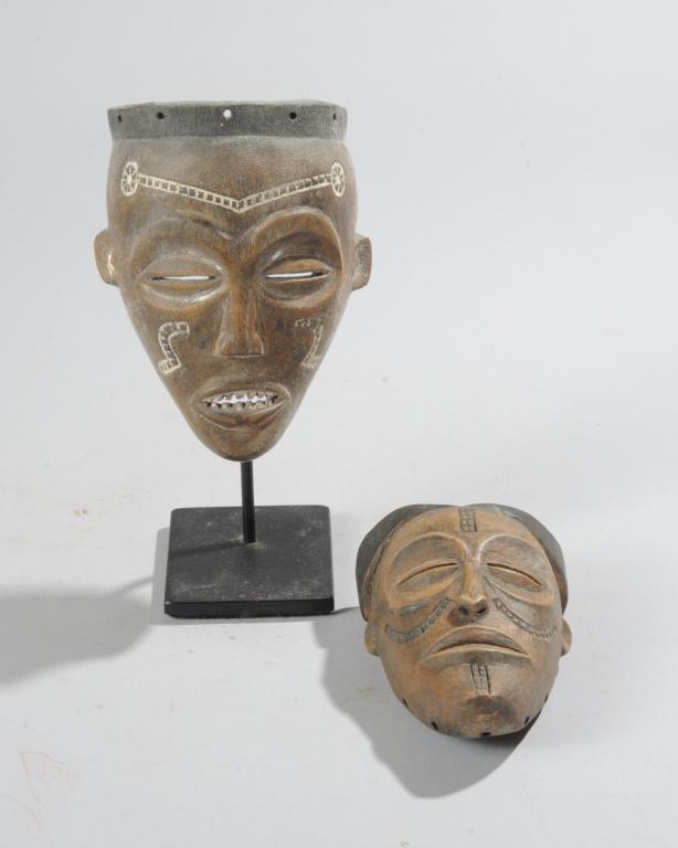 Two African Passport Masks: Possibly Chokwe / Lwena. The larger on custom stand. Masks, approx. 5 1/2" x 4" x 2 1/4" and 4 1/2" x 3" x 2". Provenance: Estate of Thomas McNemar, (1931-2020.) McNemar lived and collected throughout