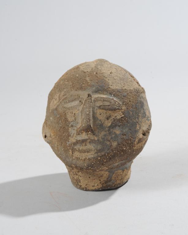 Akan Memorial Head, Ghana: Round head molded of coarse clay, with simple, serene features. Loss to area at back of head. Approx. 4 1/2" H.Provenance: Estate of Thomas McNemar, (1931-2020.) McNemar lived and collected throughout