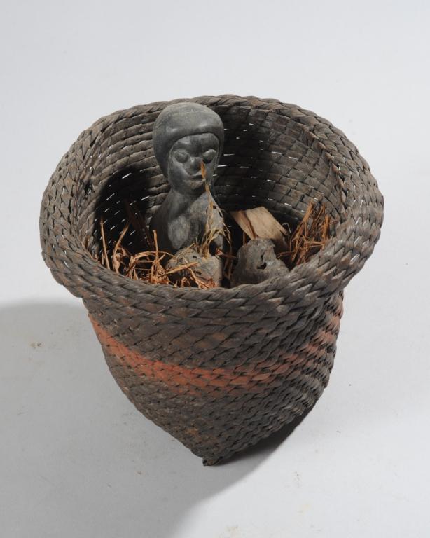 African Fetish / Power Basket: Tightly woven basket containing a carved wooden female figure, and with animal fur, grasses, and other objects embedded in organic material. Shrine / fetish type object. Basket approx. 6" H, 7" D. Pro