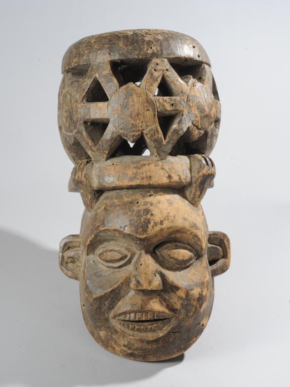 Bamun Bamum Helmet Mask: Openwork headdress above smiling, full-cheeked face, Bamun artist, Cameroon. Approx. 21" H. Provenance: Estate of Thomas McNemar, (1931-2020.) McNemar lived and collected throughout Central and West A