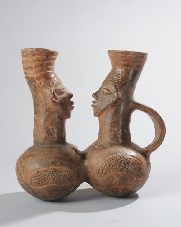 Mangbetu Palm Wine Vessel: Figural palm wine vessel in the form of a pair of confronting male and female figures, both with the elongated head and high, flaring crown of braids that embodies the Mangbetu ideal of elegance, (and