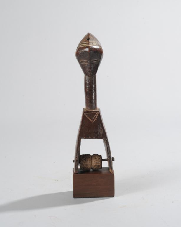 Guro Heddle Pulley, Ivory Coast: Finial of a long necked Guro woman with high coiffure. Incised and relief detail. On custom gallery stand. Total height, approx. 10 3/4". Provenance: Estate of Thomas McNemar, (1931-2020.) McNemar liv