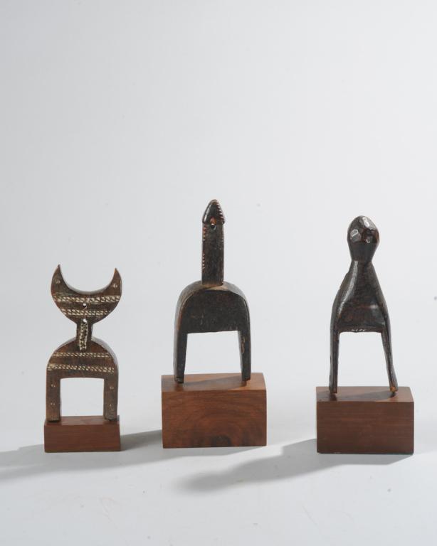 Three West African Heddle Pulleys: Of abstract form. Ivory Coast. All on custom gallery bases. Tallest (height including stand,) Approx. 9 1/4". Provenance: Estate of Thomas McNemar, (1931-2020.) McNemar lived and collected throughout