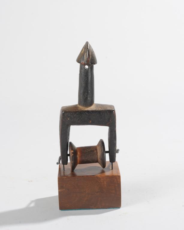 Mossi Heddle Pulley, Burkina Faso: Abstract finial with long neck and vaguely avian head. On custom gallery base. Total height, approx. 8" H. Provenance: Estate of Thomas McNemar, (1931-2020.) McNemar lived and collected throughout Cen