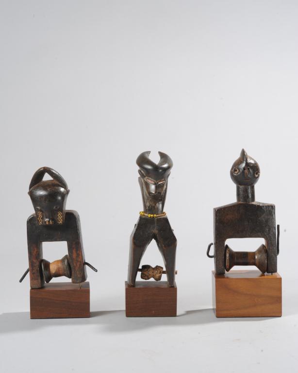 Three West African Heddle Pulleys: Baule and Guro, Ivory coast. All on custom gallery stands. The tallest approx. 8 3/4" total height. Provenance: Estate of Thomas McNemar, (1931-2020.) McNemar lived and collected throughout Central an