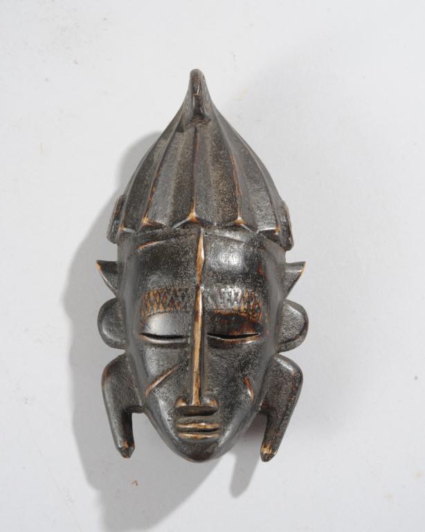 Ligbi / Senufo Miniature Mask: Finely carved miniature mask, Ivory Coast. Approx. 7 1/2" x 4" x 2 1/2". Provenance: Estate of Thomas McNemar, (1931-2020.) McNemar lived and collected throughout Central and West Africa in the 1960s 
