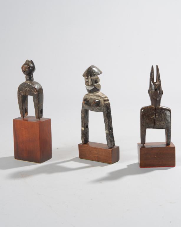 Three West African Heddle Pulleys: Likely Bamana, Guro, and Djimini. All on custom gallery bases. Tallest (total height, including base,) approx. 7 1/4" H. Provenance: Estate of Thomas McNemar, (1931-2020.) McNemar lived and collected