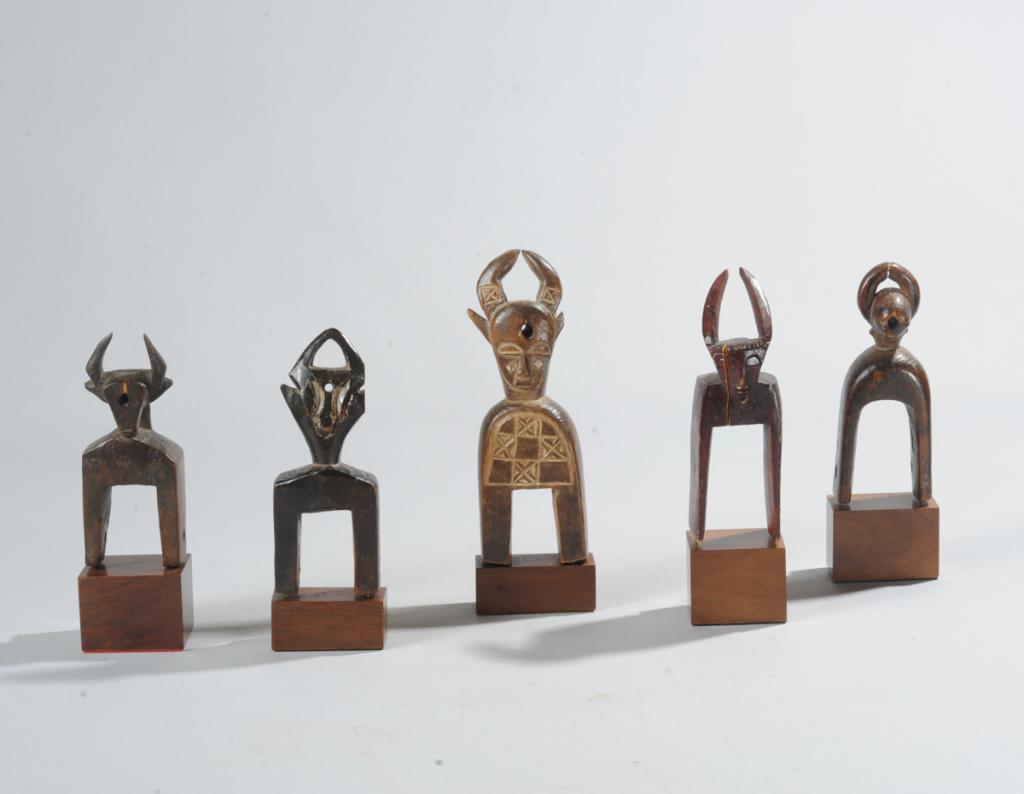Five West African Heddle Pulleys: All five having horned finials, likely all from Ivory Coast. One with ear broken off, another with crack. All with custom gallery bases. Tallest, including base, approx. 7 1/2" H. Provenance: Estate o