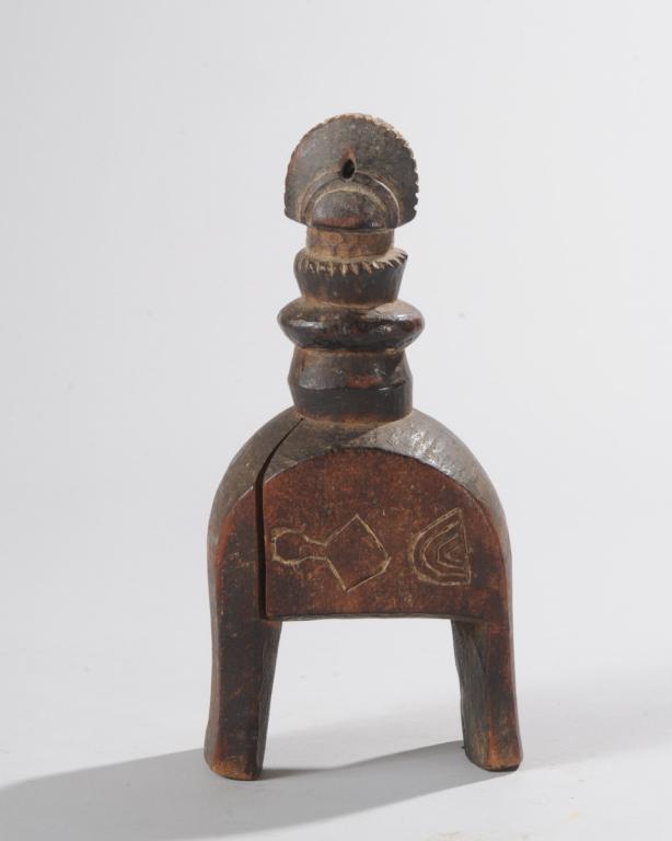 African Heddle Pulley: Possibly a Mossi pulley, Burkina Faso, the finial resembling the head of a Mossi 'Biiga' Doll. Lower part with incised symbols. Approx. 8" H x 2 1/4" x 3 3/4". Provenance: Estate of Thomas McNemar, (1