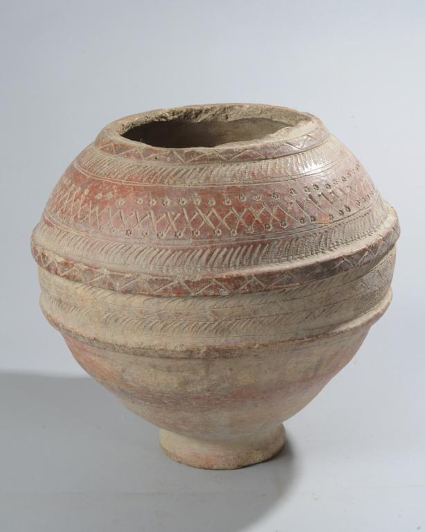 Bozo Terracotta Pot, Mali: Large round pot on low foot with raised bands and heavily incised dot, linear, sawtooth and diamond patterned borders. Rim rough, chips. Approx. 15 1/2" H x 16" D. Provenance: Estate of Thomas McNemar