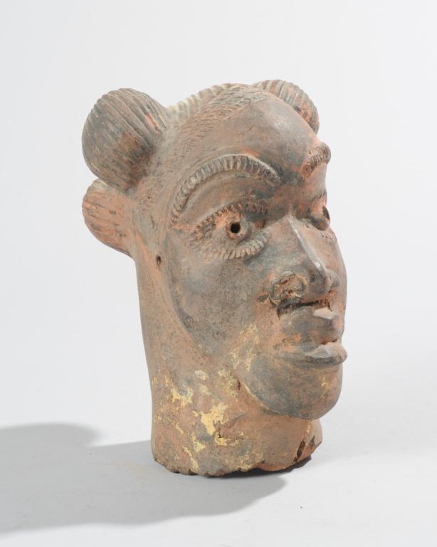 Nok Style Terracotta Head, Nigeria: Pottery head, the hair elaborately arranged in four orbs, made in the style of the ancient Nok culture terracotta figures found throughout Nigeria. Age unknown. Repairs. Approx. 7 1/2" H. Provenance: