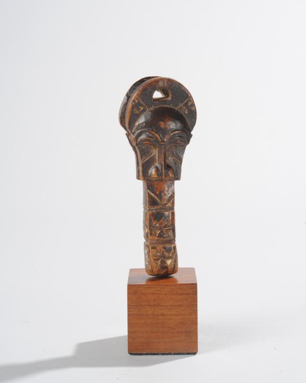 Baule Carved Object, Ivory Coast: Nicely carved object, possibly some kind of spool or loom part, with buffalo mask head on each side above chip carved post. Mounted to custom gallery stand. Object, approx. 5 1/8" H. Total height with