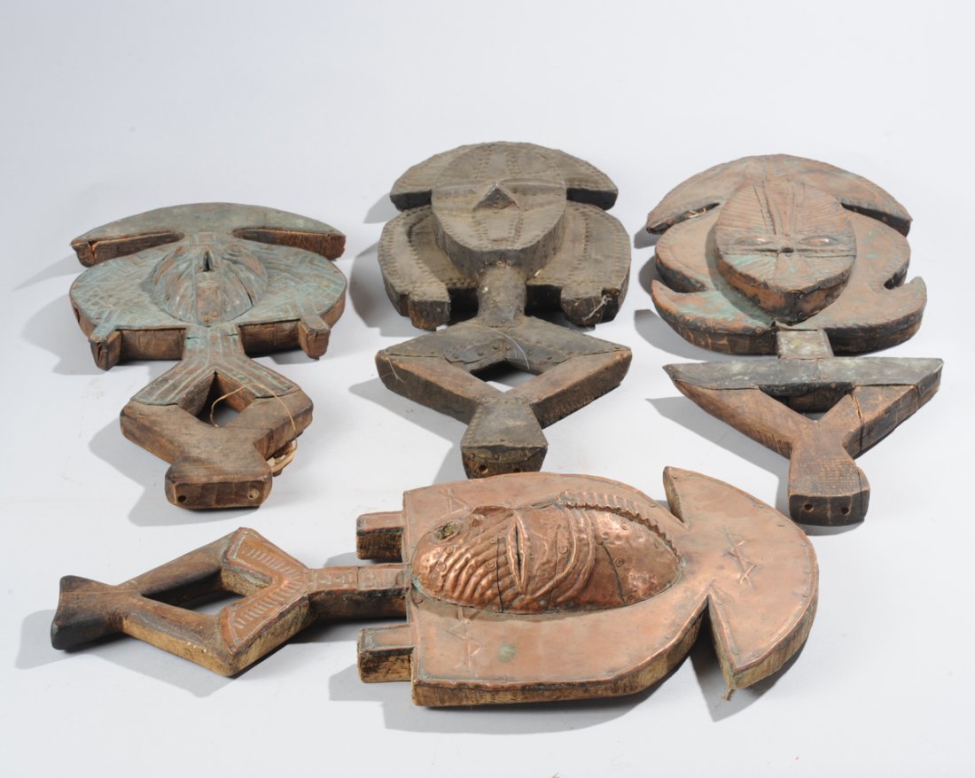 Lot of Four Kota Mbulu-Ngulu Reliquary Figures: Of the type used to guard baskets of ancestral relics. Four variations on the form, copper and brass clad figures, all with convex oval face with tri-part coiffure, diagonal lines like tears below the